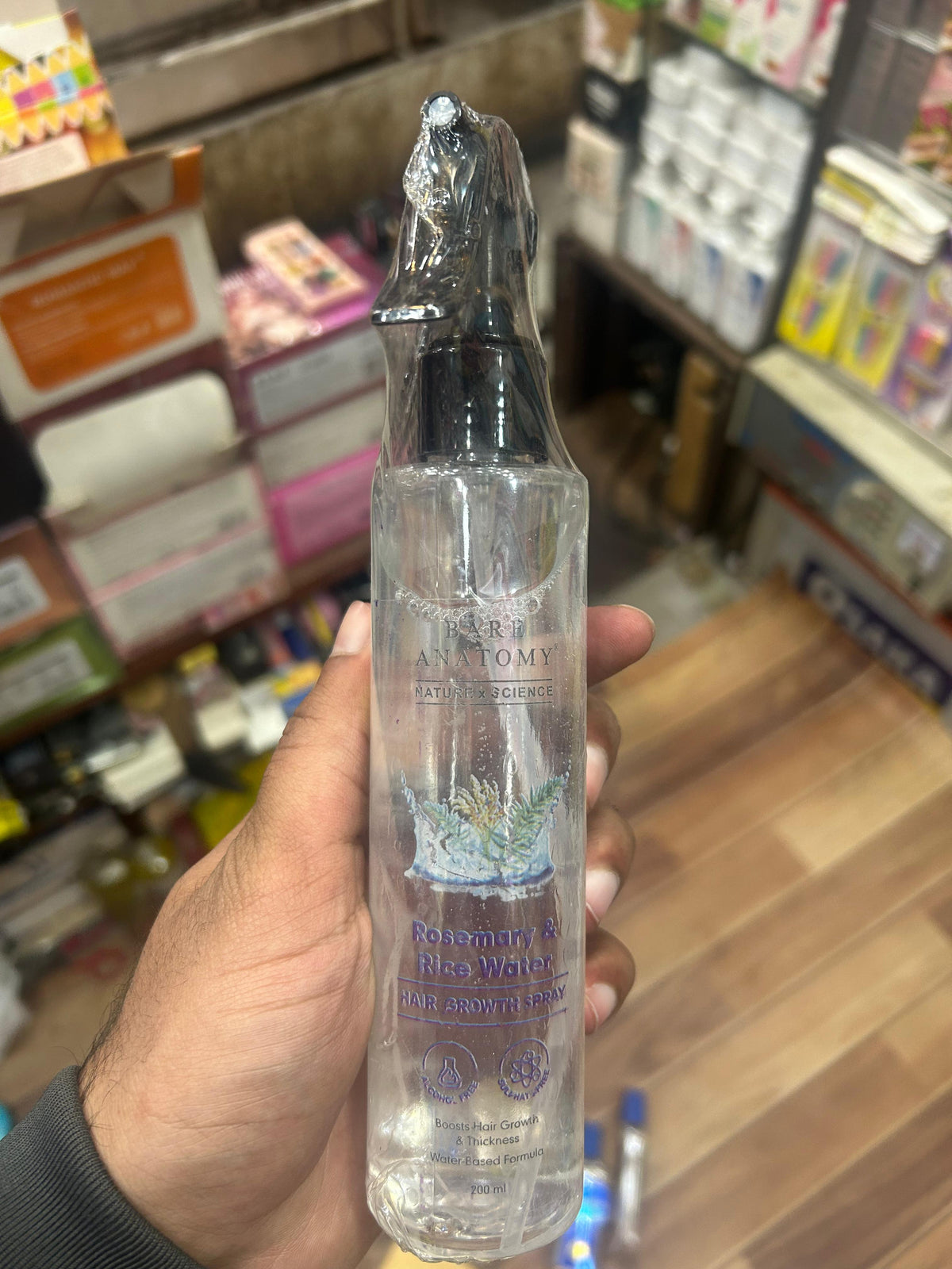Hair growth spray in 200ml bottle from SS Smart Shop, with natural ingredients and spray nozzle for easy application.
